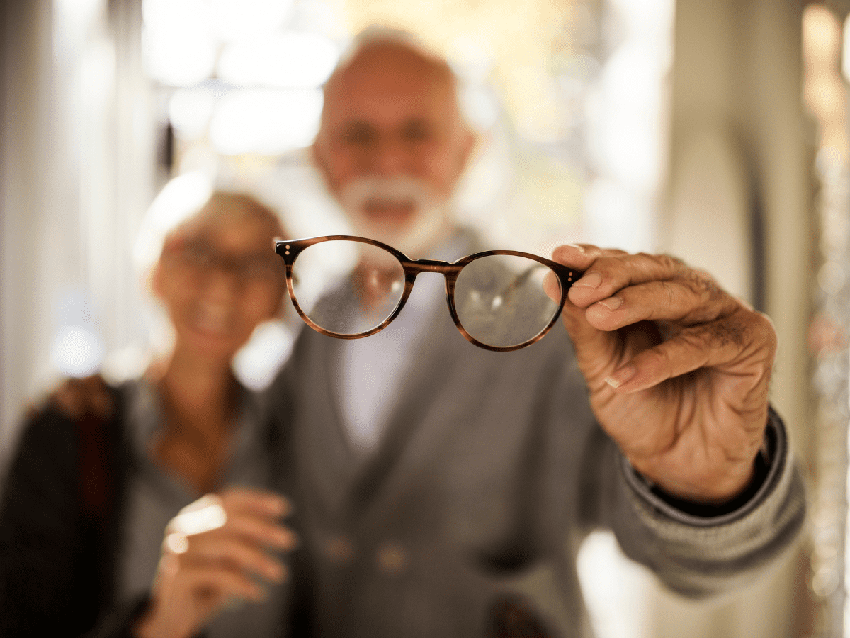 Man holding eyeglasses