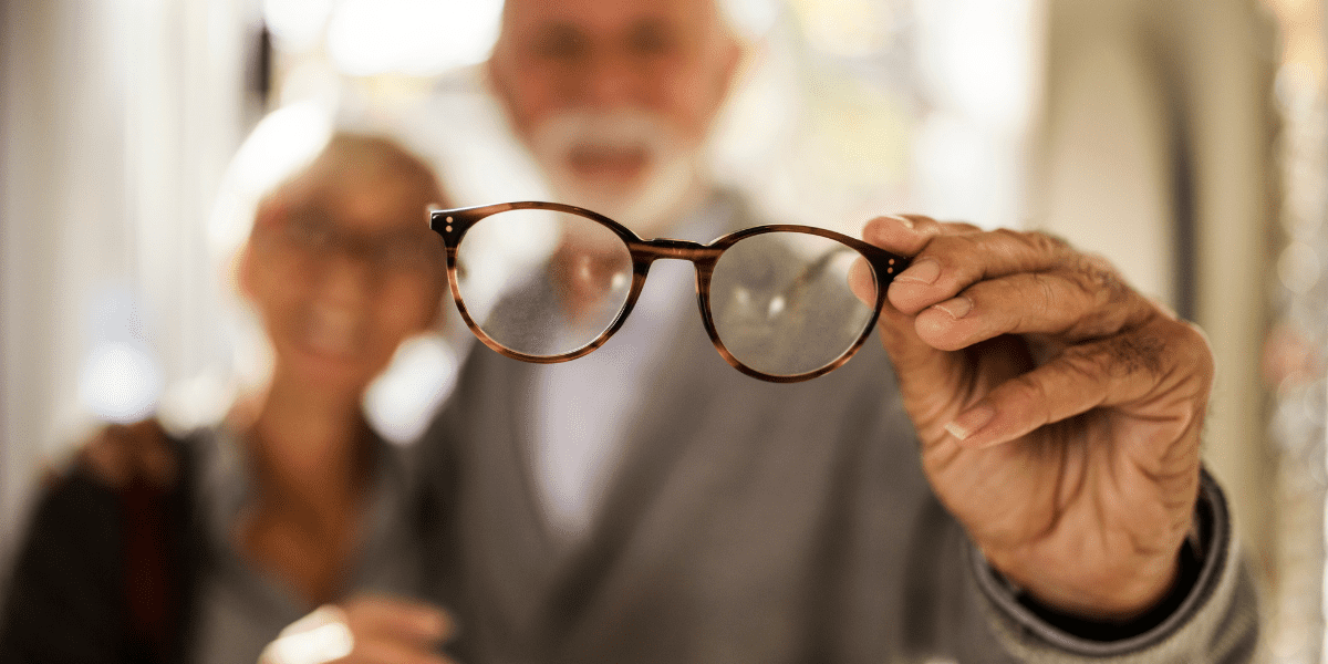 Man holding eyeglasses