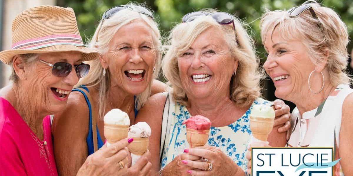 Four women smiling and eating ice cream
