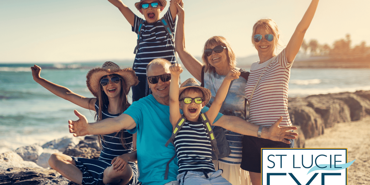 Family enjoying a sunny day at the beach together, with grandparents, parents, and children all wearing sunglasses to protect their eyes from UV rays and stay safe in the sun.