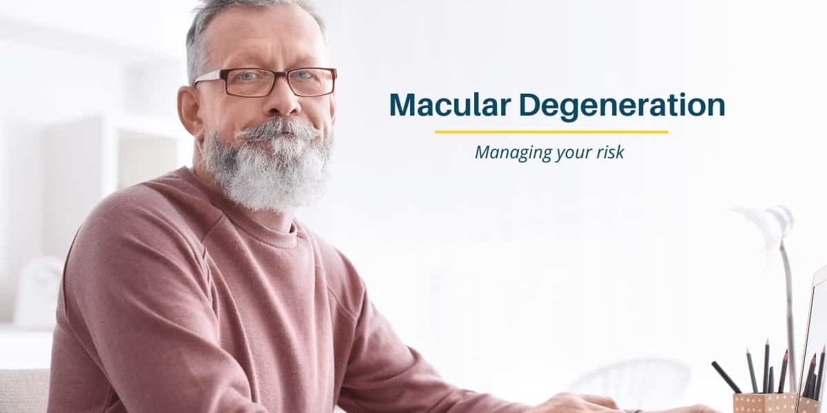 Grey haired man wearing glasses searching for information on Macular Degeneration on a laptop computer
